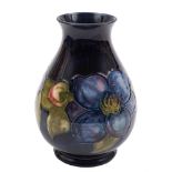 A Moorcroft pottery vase: of tear drop form with flaring neck tubelined in the blue Clematis