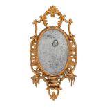 An 18th Century carved giltwood mirror: of cartouche-shaped outline, having open cartouche,
