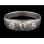 A platinum and gypsy-set diamond three-stone ring: with circular,