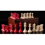 A Staunton pattern bone chess set: one side stained red, the other left natural, the king 9cm.
