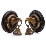 A pair of late 19th century gilt brass wall light fittings: in the form of eagle heads with