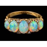 A graduated opal five-stone ring: the oval opals graduate from approximately 5mm long to 7.