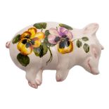 A pair of Exon Ware Wemyss pottery sleeping pigs: one painted with oranges and foliage the other