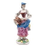 A Bow figure of Matrimony: in the form of a lady holding a lantern-style birdcage,