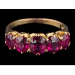 A graduated ruby five-stone ring: the oval rubies graduate from approximately 5mm long to 6mm long,