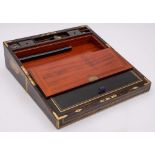 A Victorian coromandel and brass bound and strung writing box: the hinged lid enclosing a leather