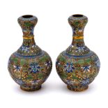 A pair of Chinese champleve enamel garlic-mouth bottle vases: each decorated with a raised design