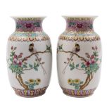 A pair of Chinese famille rose vases: each painted with an inscription and a long tailed bird