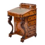 A Victorian walnut and inlaid Davenport:, of bowed breakfront outline,