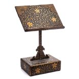 A Japanese gold lacquer book stand: in three sections, decorated overall with scrolling prunus,