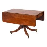 A Regency mahogany drop flap breakfast table:, the hinged top with rounded corners,