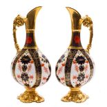 A pair of Royal Crown Derby ewers: in the 'Old Imari' pattern with solid gold borders,