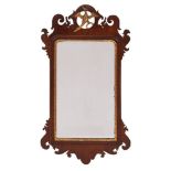 A 19th Century mahogany and partly gilt fret-cut mirror: with Ho-ho bird and shaped cresting,