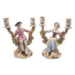 A pair of Meissen two-branch figural candelabra: in the form of a gallant and lady in 18th century
