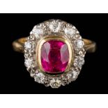 A synthetic ruby and diamond cushion-shaped cluster ring: the cushion-shaped synthetic ruby