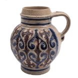 A German Westerwald stoneware jug: moulded and painted in blue and manganese with a repeated design