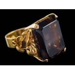 A rectangular smoky quartz, single-stone dress ring: with foliate shoulders, approximately 16.