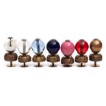 A group of seven Chinese Mandarin hat finials: the different coloured glass balls mounted on gilt