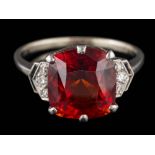 A cushion-shaped hessonite garnet and diamond ring: the hessonite garnet approximately 11.