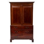 A 19th Century mahogany linen press:, the upper part with a moulded dentil cornice,