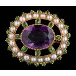 An amethyst, seed pearl and demantoid garnet-set oval brooch: approximately 25mm overall length, 5.