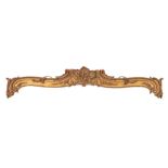 A Victorian carved giltwood pelmet: of rococo scroll design centred by scrolling rocaille and