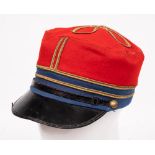 A French red and blue cloth Kepi: with gilt braid line to sides and knot to top, black leather peak,