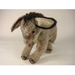 A mid 20th century grey plush Steiff donkey: with button to one ear, black button eyes,