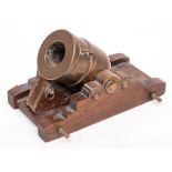 A late 19th century brass and oak model of a mortar:,