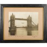 An early 20th century photograph of a hydroplane flying though Tower Bridge, circa 1912:,