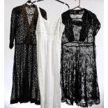 A mid 20th century black lace over dress and one other similar,