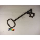 An early 20th century large iron key, possibly a shop advertising sign:, 54cm long.