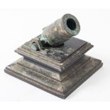 A 19th century cast bronze desk mortar on an ebony plinth, 12cm high.