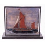 An early 20th century cased waterline model of the Thames Barge 'E & Co',