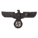 A reproduction WWII German Eagle crest: together with a silver plated trumpet with reproduction