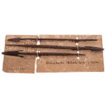 Three African metal arrow heads (Matabele Land) South Africa: mounted on card, each 18.5cm. long.