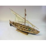 A scale model of a whaling boat: running rigged over detailed decks with oars,