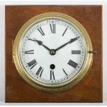 A circular brass bulkhead clock:,