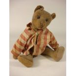 An early 20th century blonde plush Teddy bear: with boot button eyes and remains of stitched mouth