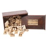 An early 19th century bone 'Spelling Alphabet' in mahogany box: comprising eighty two tiles with