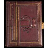 An Edwardian Musical Cabinet photograph album: with floral lithographed pages and part filled with