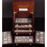 A set of Danbury Mint 'British Coins of World War II' in a collectors cabinet.