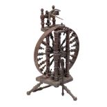 A 19th Century fruitwood Castle pattern spinning wheel: with urn-shaped turned spindle spokes and