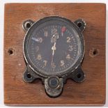 A WWII Japanese Seikosha Model 100 aircraft clock: the black dial with luminous Arabic numerals and