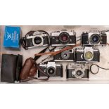 A group of eight 35mm SLR cameras: including an Exata Vares IIb, an Olympus Trip 35,