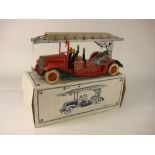 A tinplate clockwork fire engine,: with silver turntable and ladder, red lithograph printed cab,