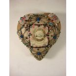 A First World war sweetheart cushion: the central celluloid panel surrounded by beaded pins and