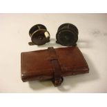 Two brass four bar reels and an Army & Navy leather fly wallet with steel eye flys: (3)