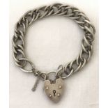 A vintage silver charm bracelet with padlock and safety chain.