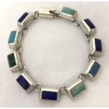 A modern design rectangular link bracelet set with various blue and green natural stones.